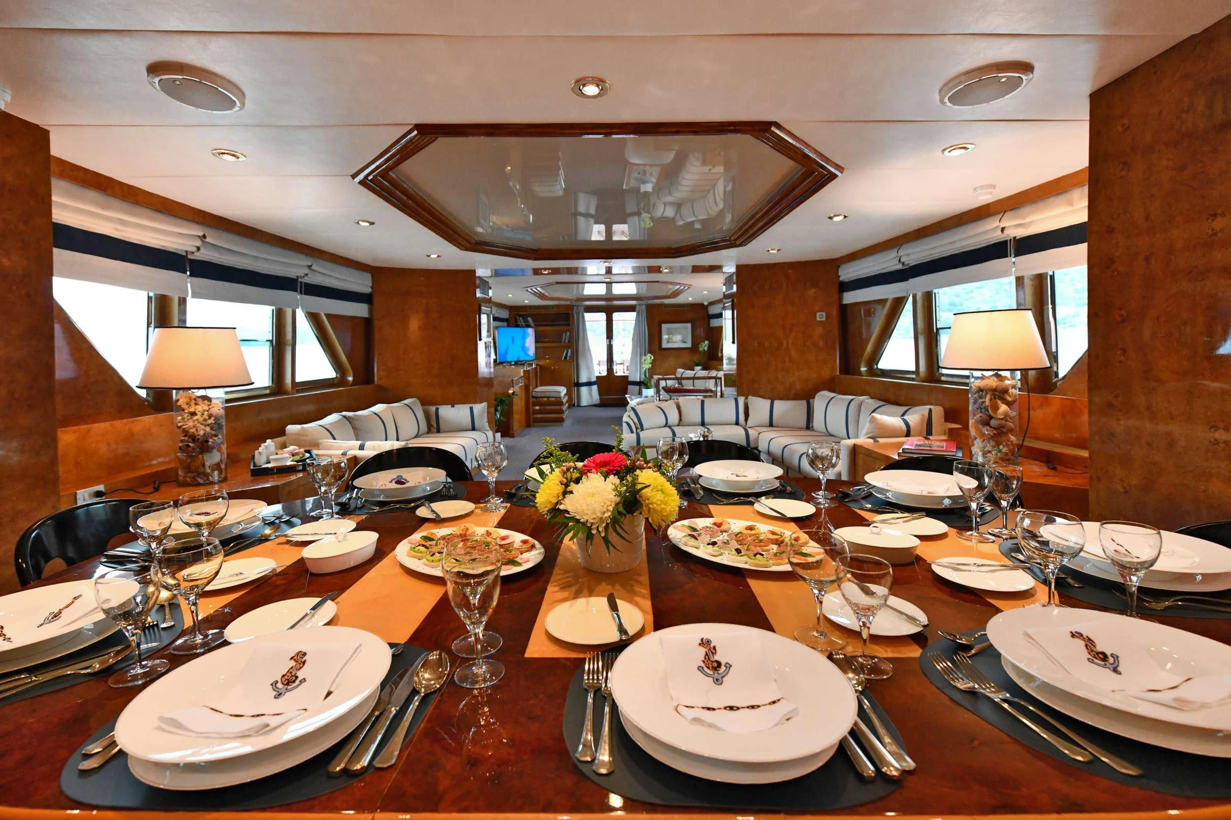 a large dining room with a large table set for a meal aboard SOMETHING COOL Yacht for Charter