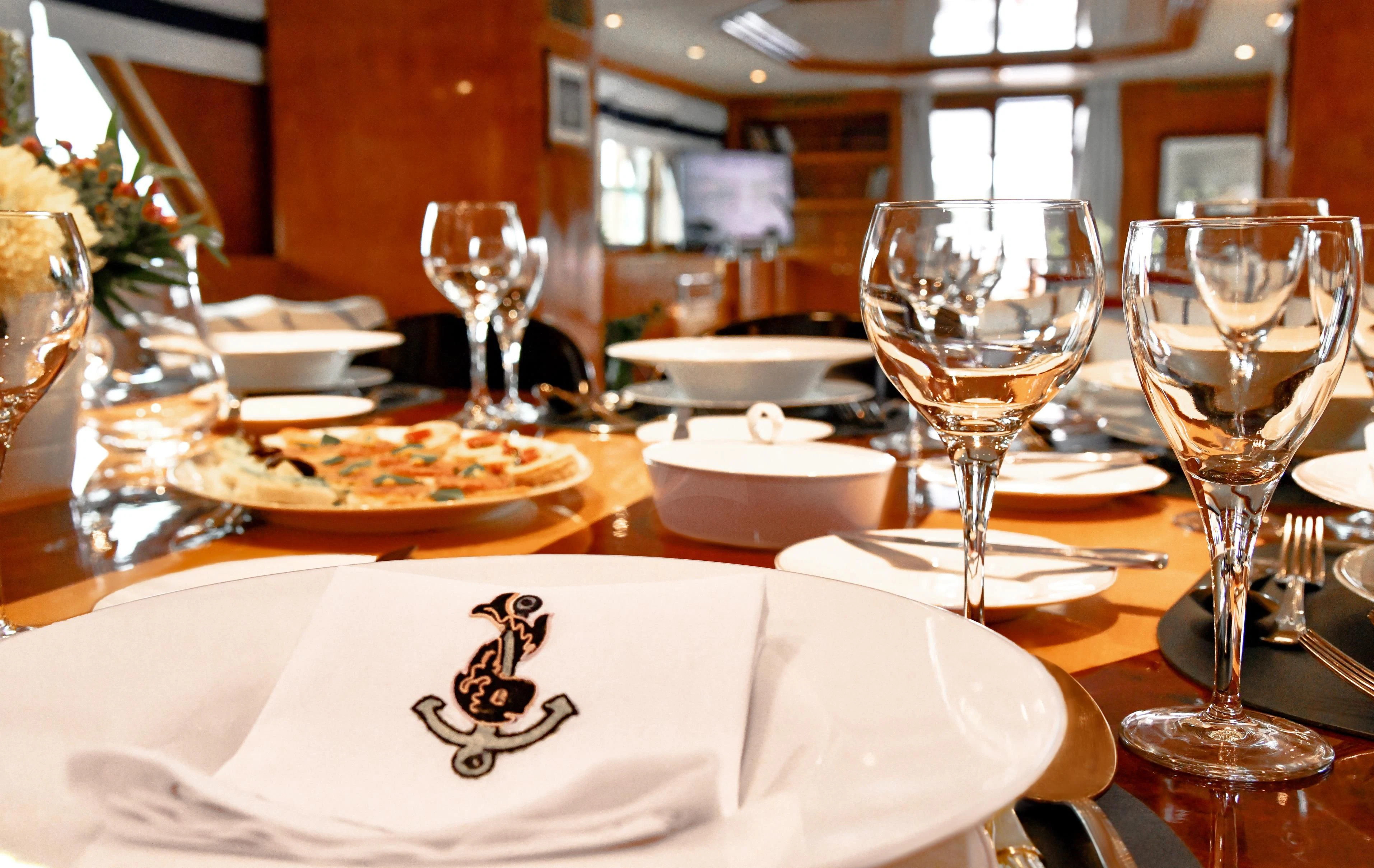 a table with food and wine glasses aboard SOMETHING COOL Yacht for Charter