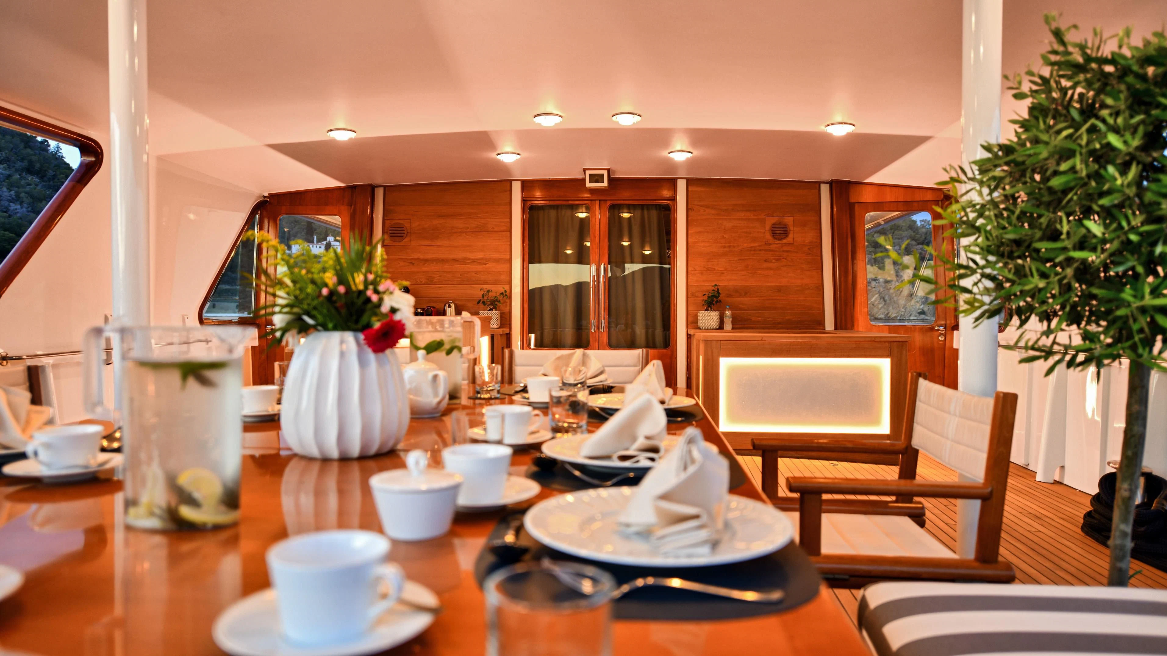 a table with plates and cups on it aboard SOMETHING COOL Yacht for Charter