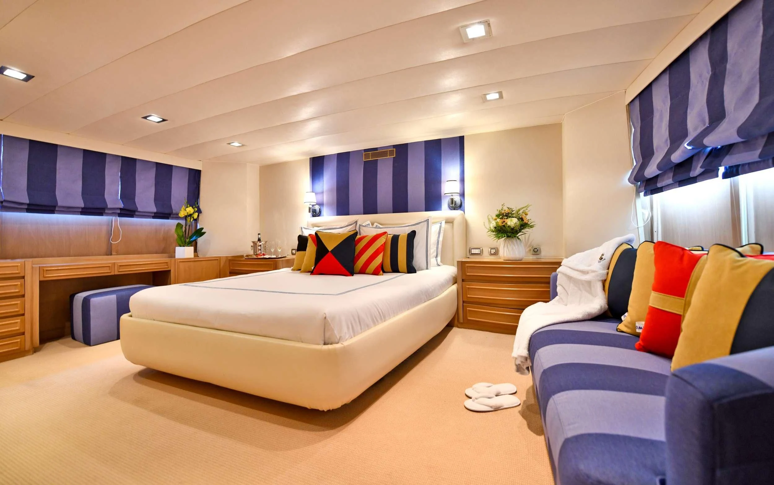 a room with a bed and a couch aboard SOMETHING COOL Yacht for Charter
