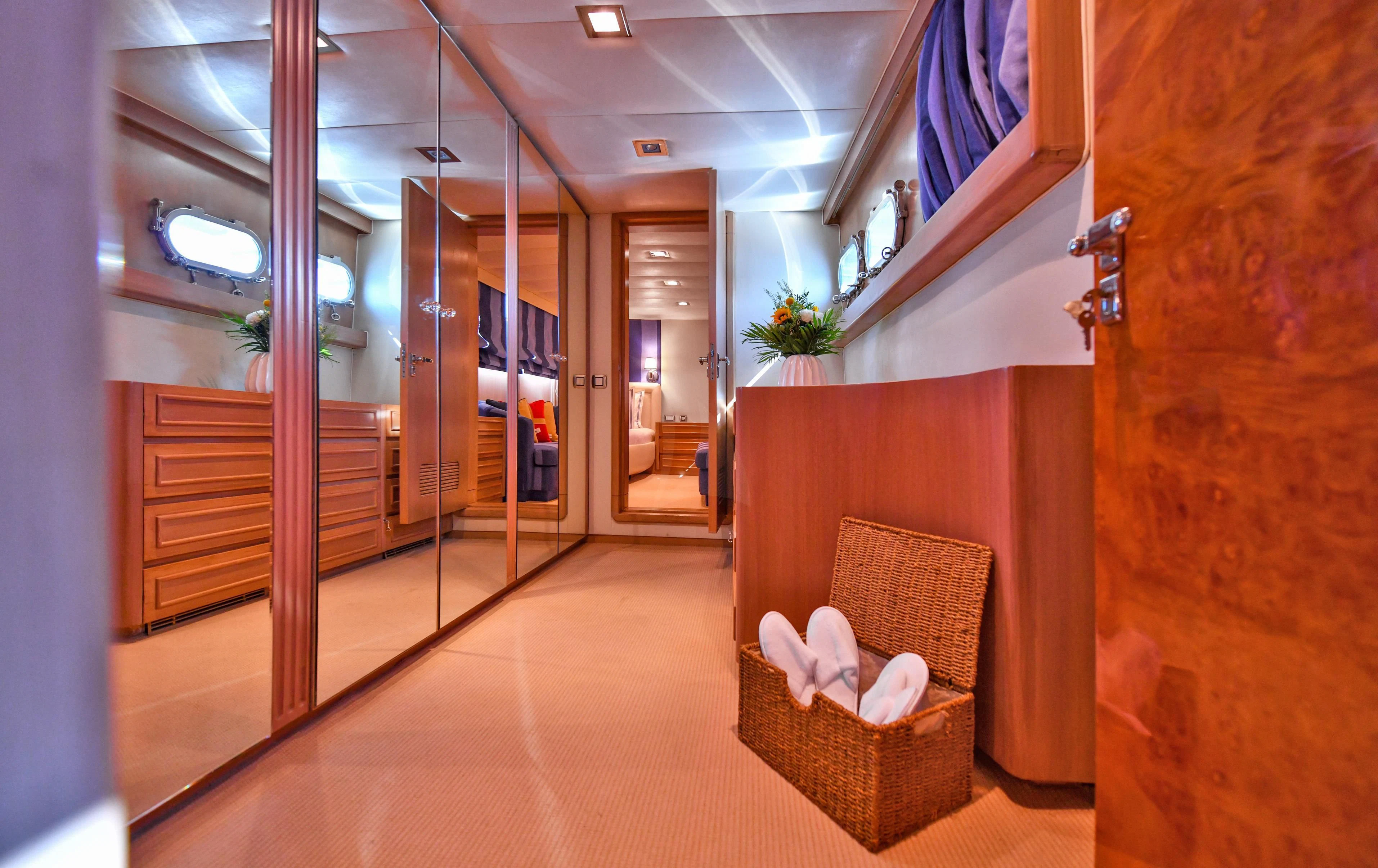 a room with a chair and a bench aboard SOMETHING COOL Yacht for Charter