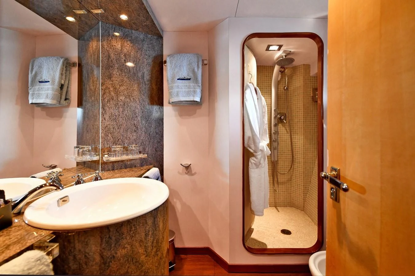 a bathroom with a large mirror aboard SOMETHING COOL Yacht for Charter