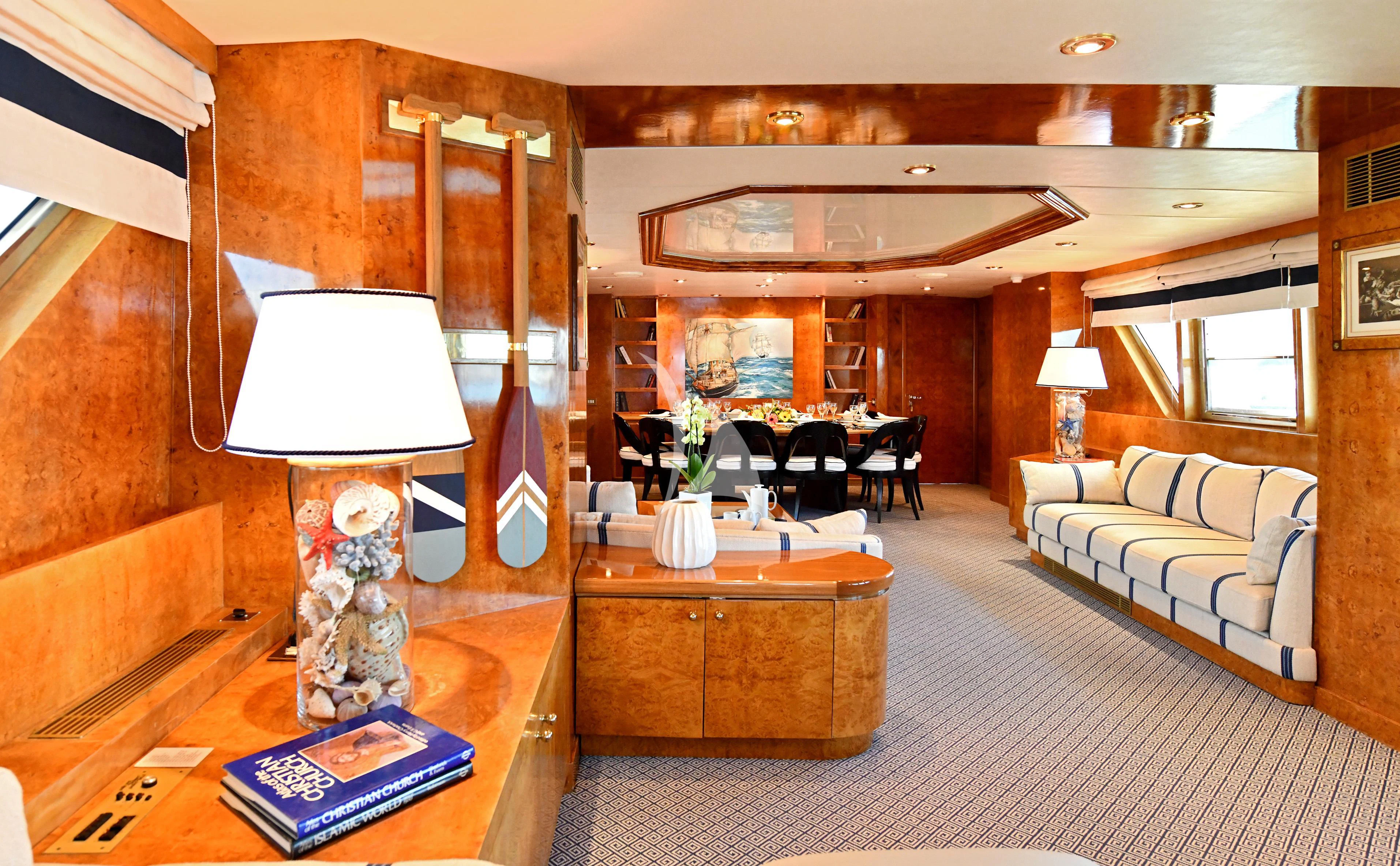 a living room with a large mirror aboard SOMETHING COOL Yacht for Charter