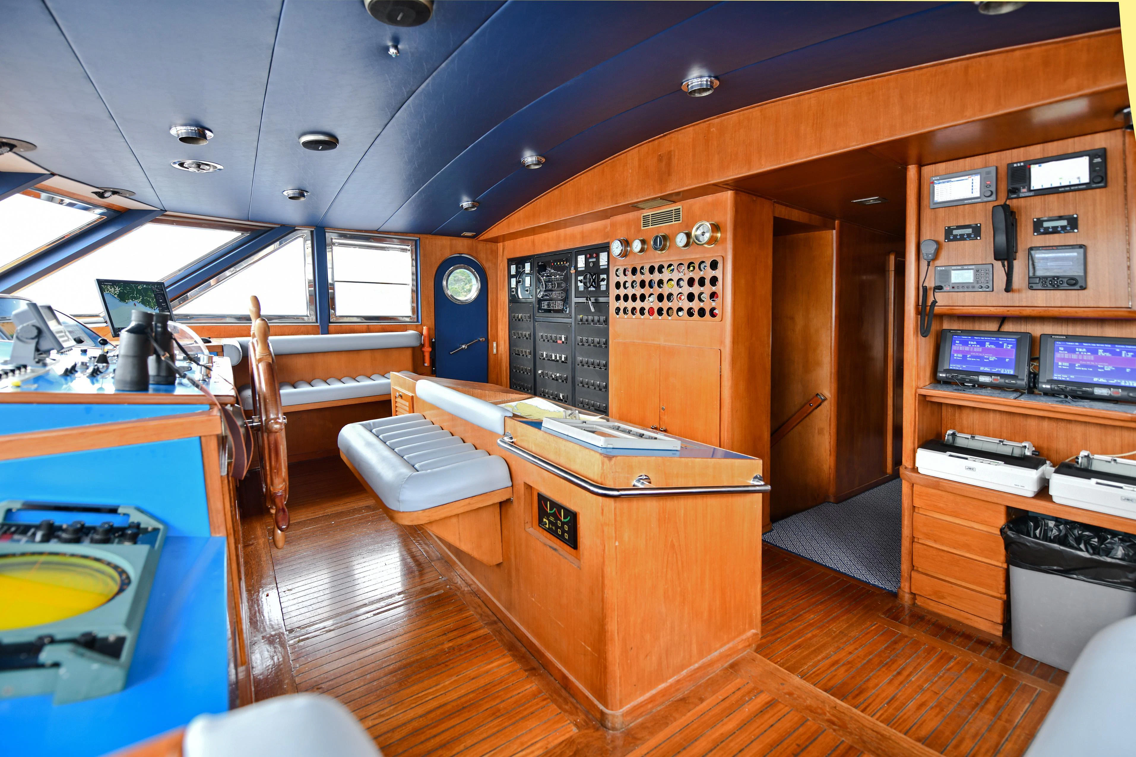 a room with a wood cabinet and a large wood cabinet with drawers aboard SOMETHING COOL Yacht for Charter