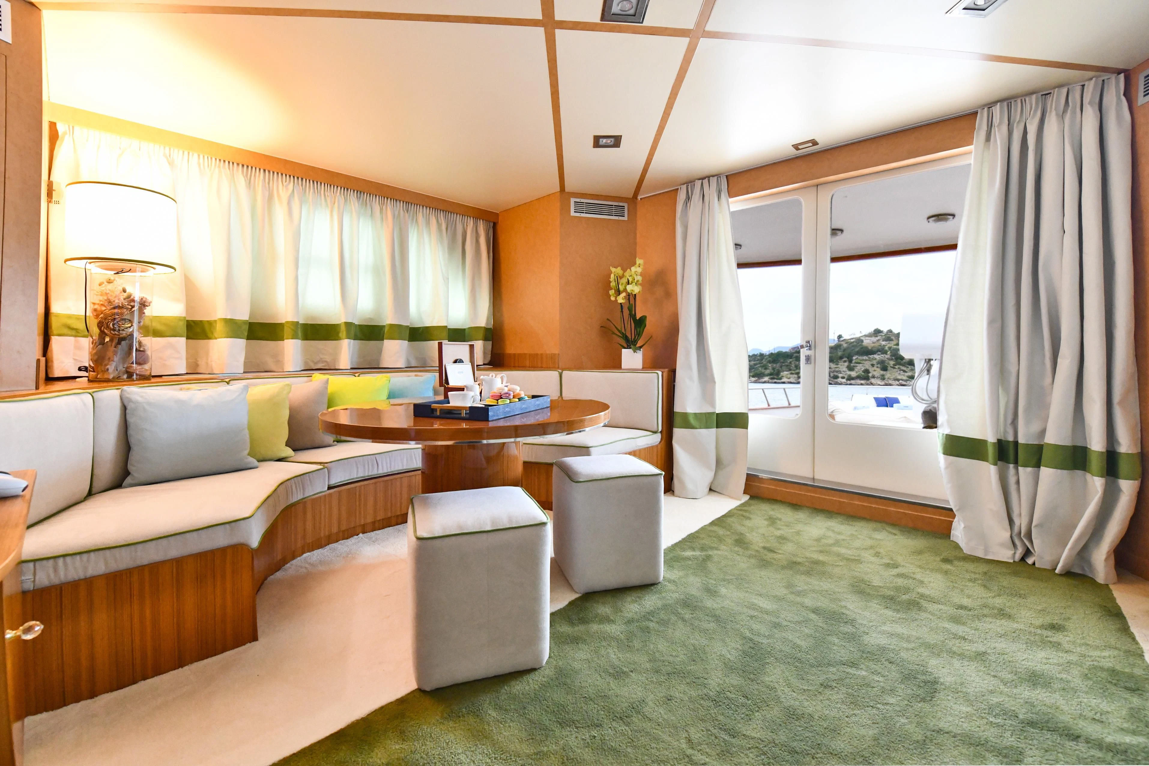 a living room with a couch and a table aboard SOMETHING COOL Yacht for Charter