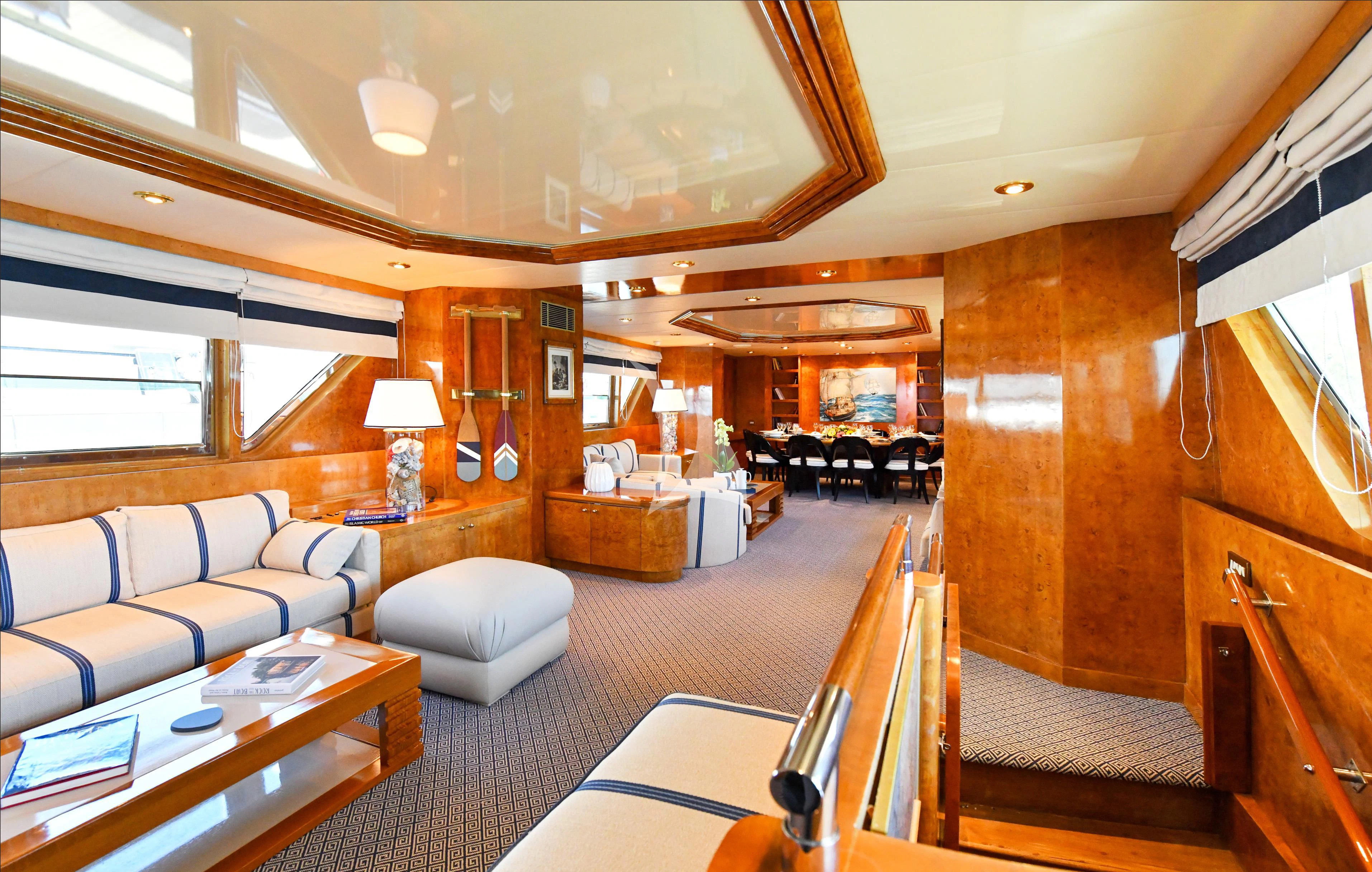 a living room with a large window aboard SOMETHING COOL Yacht for Charter