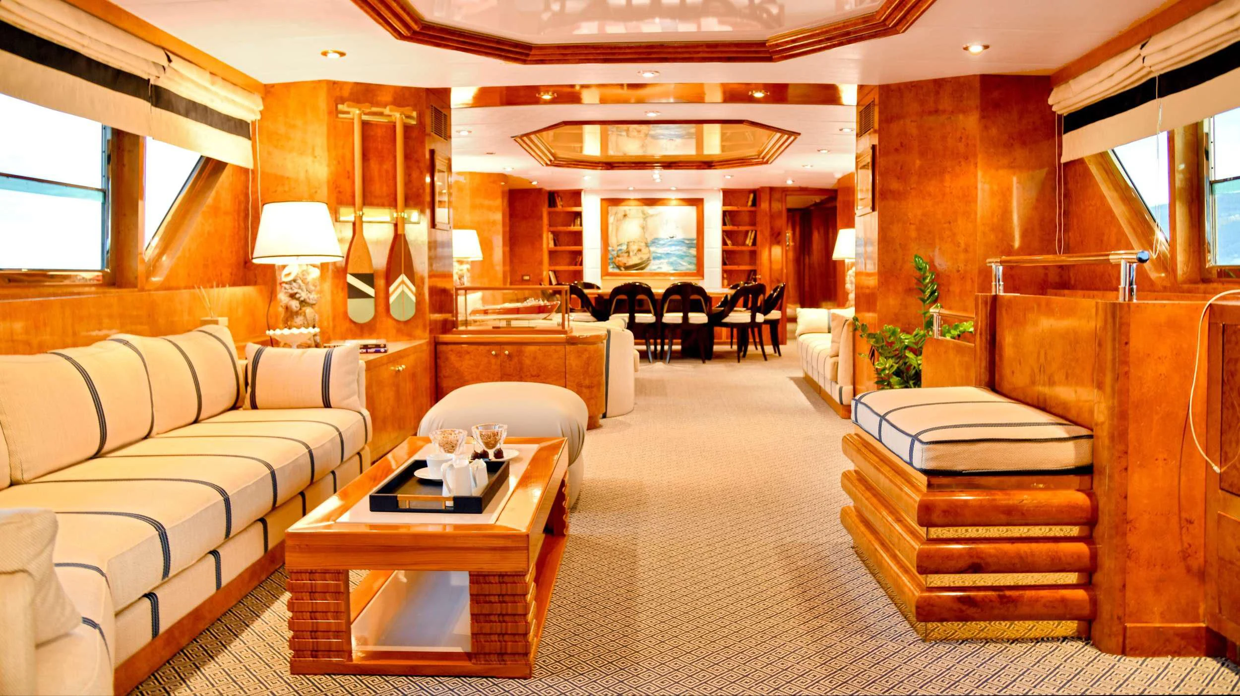 a living room with a couch and a coffee table aboard SOMETHING COOL Yacht for Charter