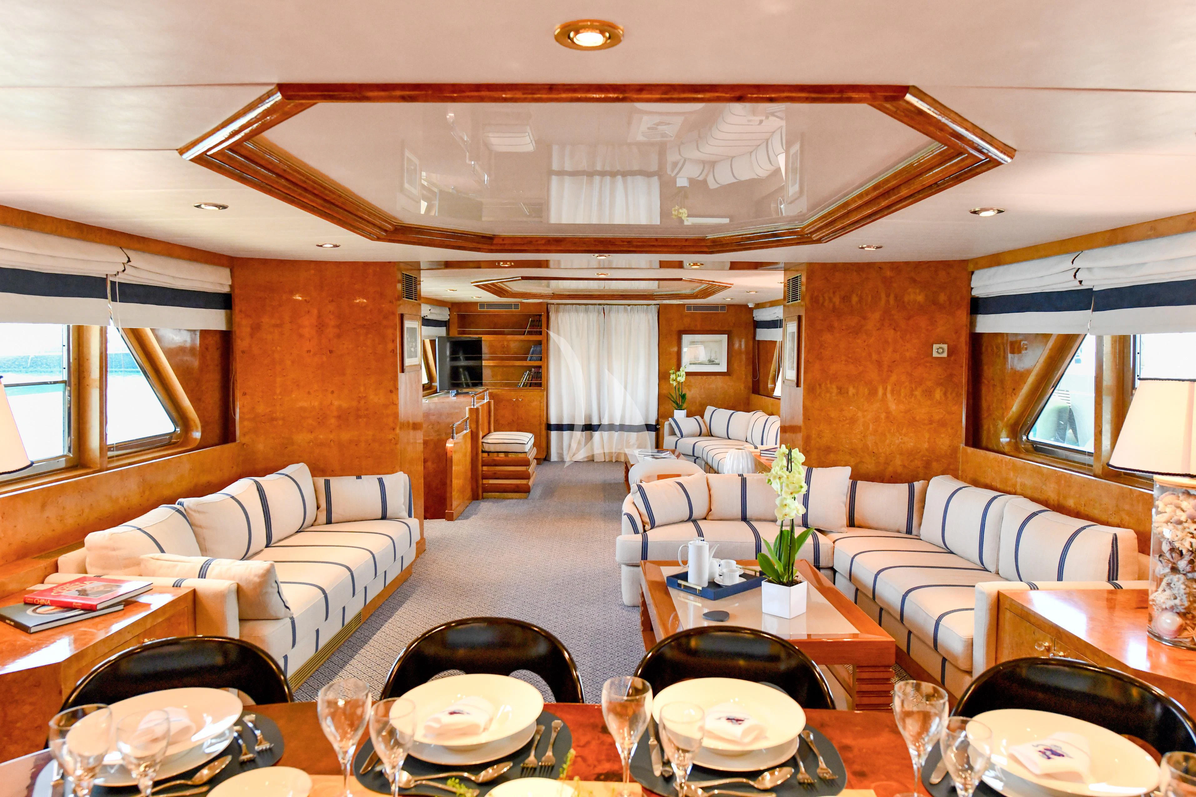 a living room with a couch and a table aboard SOMETHING COOL Yacht for Charter