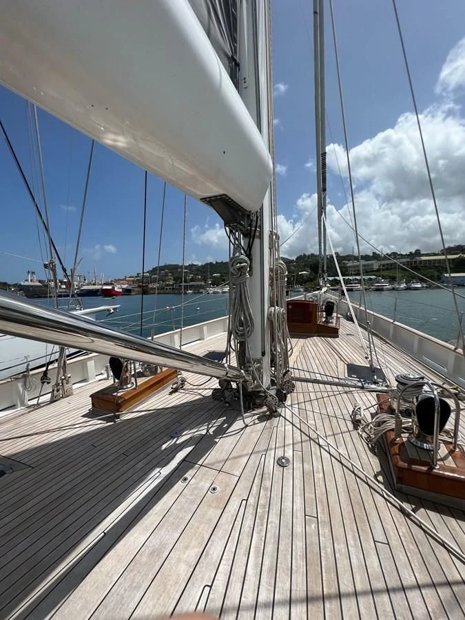 a deck with a railing and a body of water in the background aboard URIEL Yacht for Sale