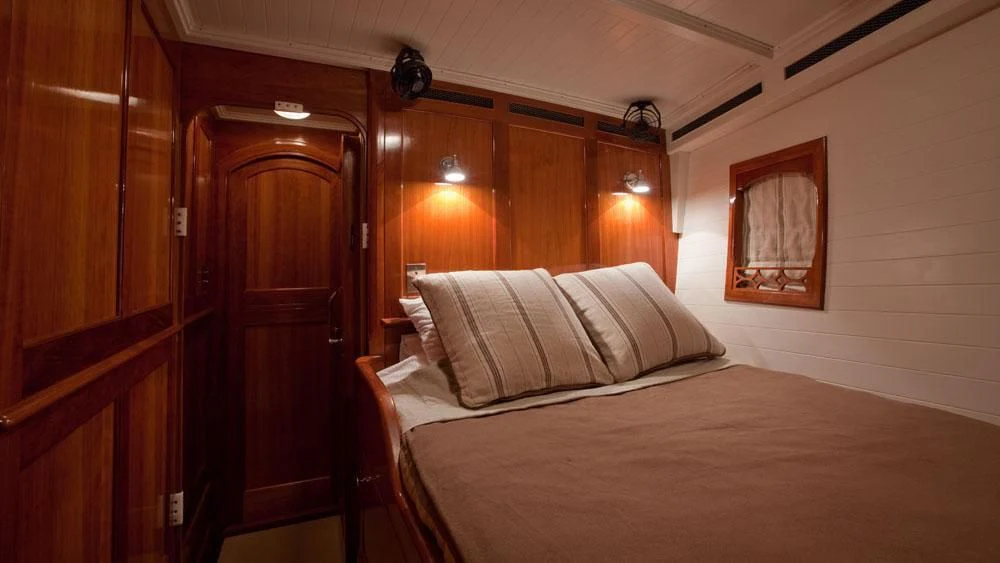 a bed in a room aboard URIEL Yacht for Sale