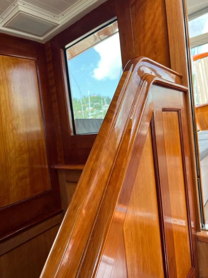 a wooden staircase with a window aboard URIEL Yacht for Sale