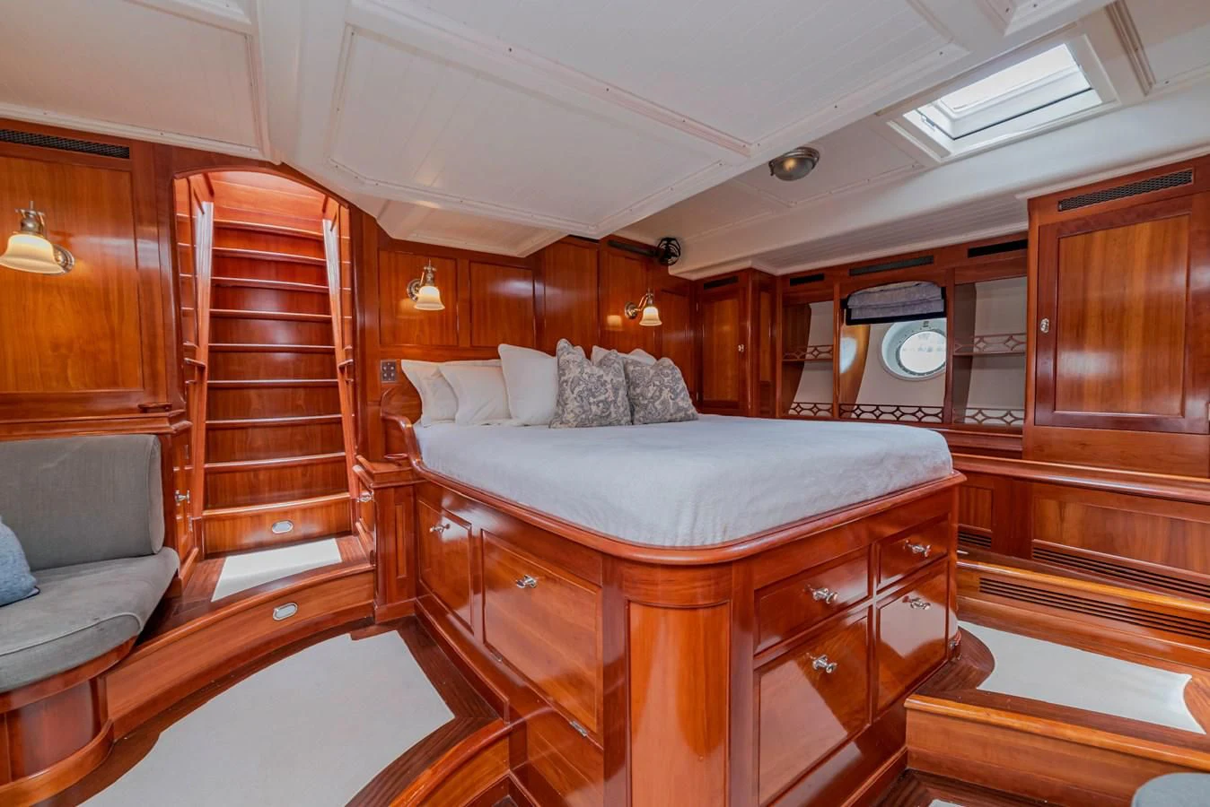 a bedroom with a bed and a couch aboard URIEL Yacht for Sale