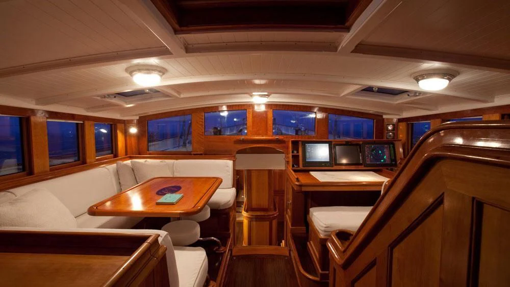a room with a table and chairs aboard URIEL Yacht for Sale