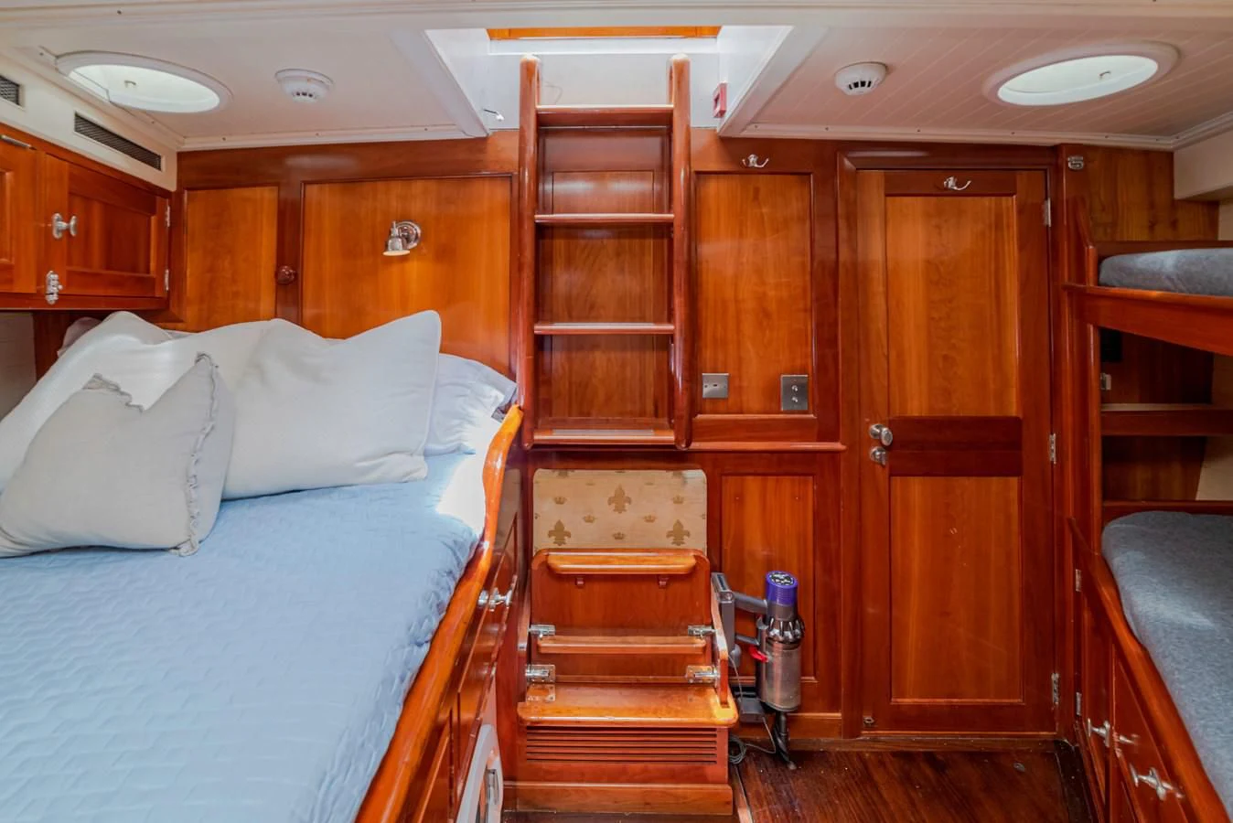 a bedroom with a bed and a desk aboard URIEL Yacht for Sale