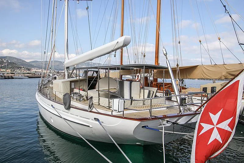 a boat with a flag on the front aboard URIEL Yacht for Sale
