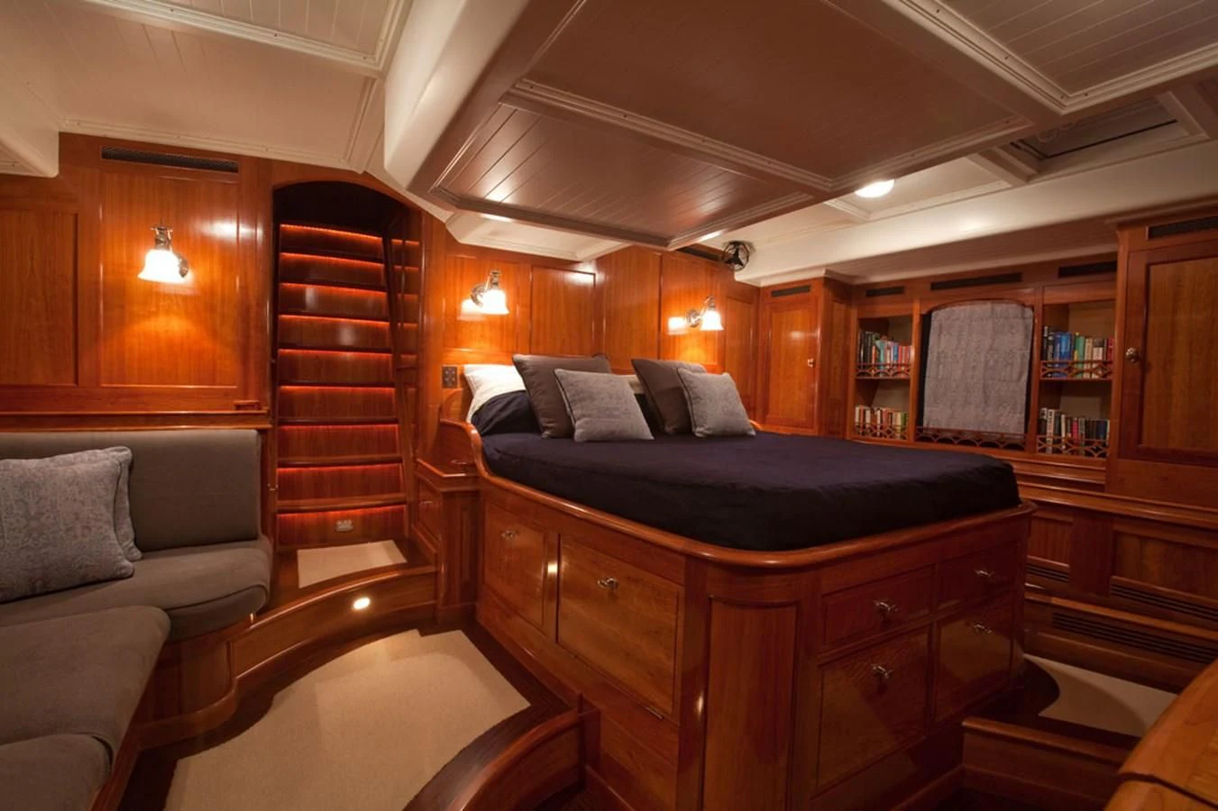 a bedroom with a bed and a couch aboard URIEL Yacht for Sale