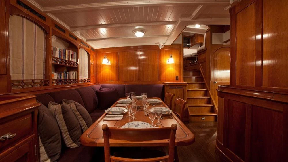 a dining table in a cabin aboard URIEL Yacht for Sale