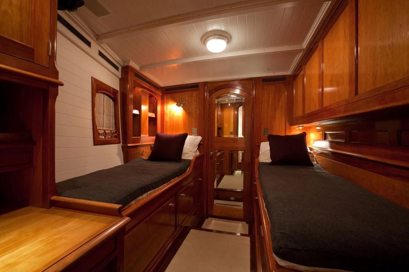 a room with a bed and a desk aboard URIEL Yacht for Sale