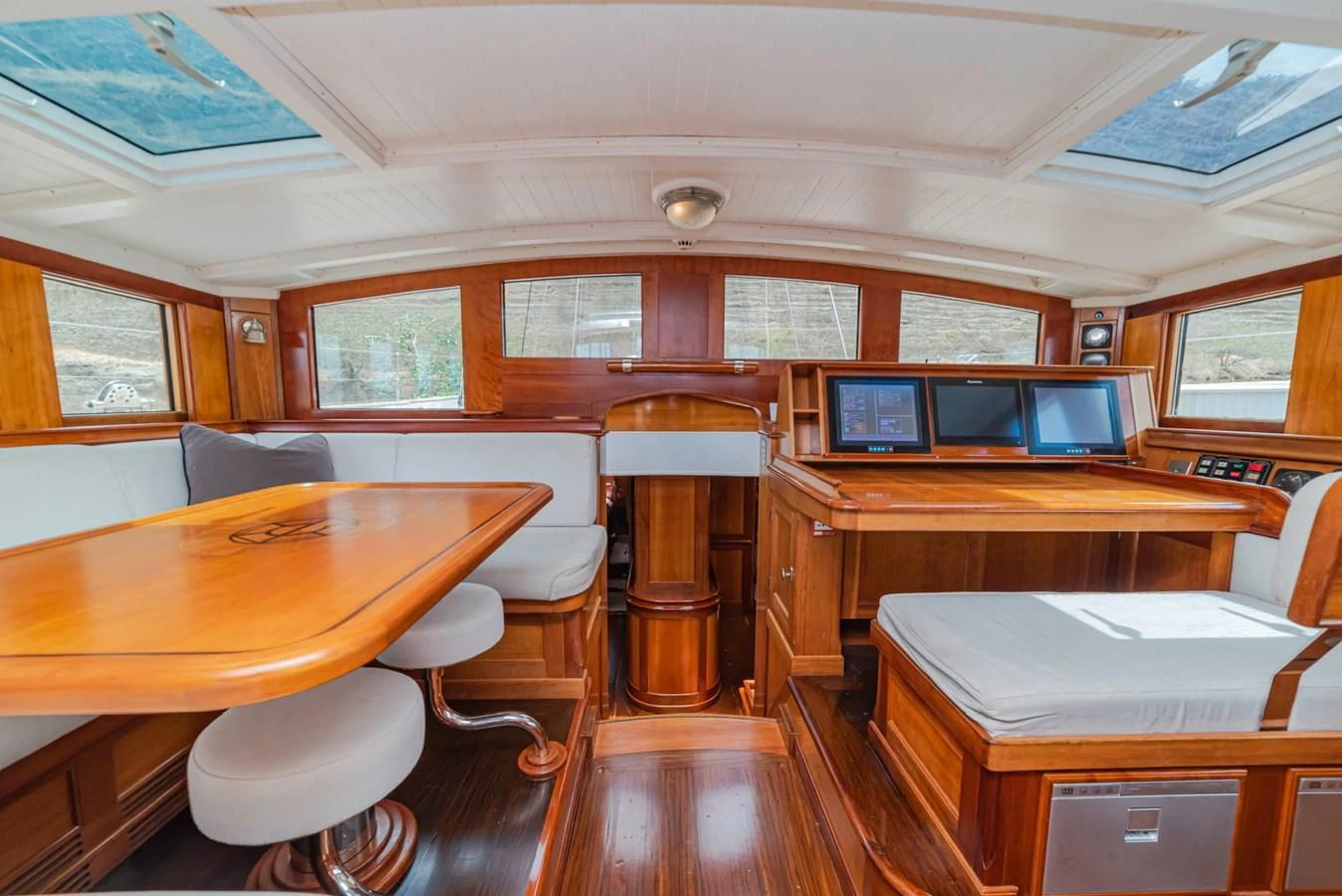 a room with tables and chairs aboard URIEL Yacht for Sale