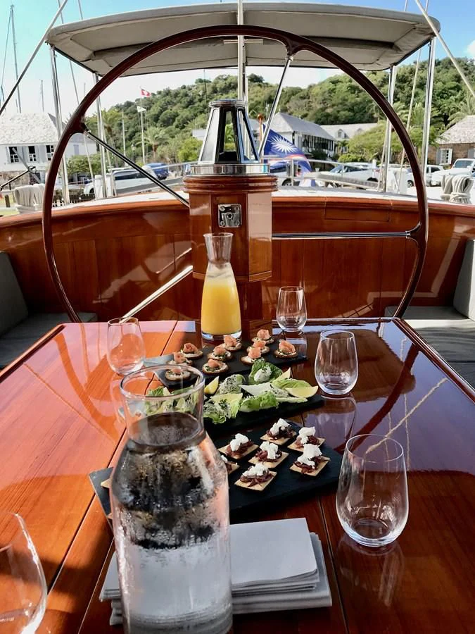a table with food and drinks on it aboard URIEL Yacht for Sale