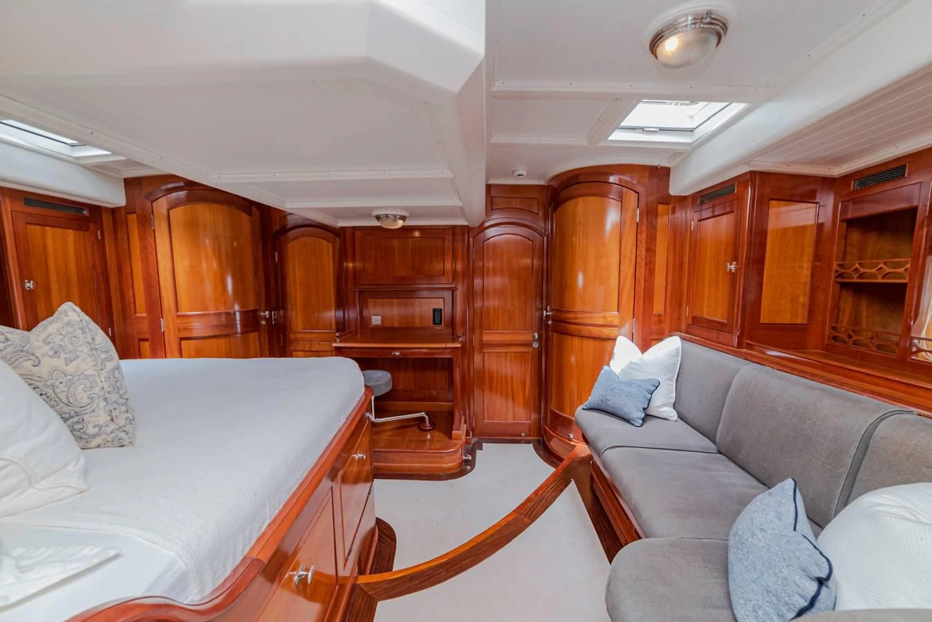 a room with a bed and a couch aboard URIEL Yacht for Sale