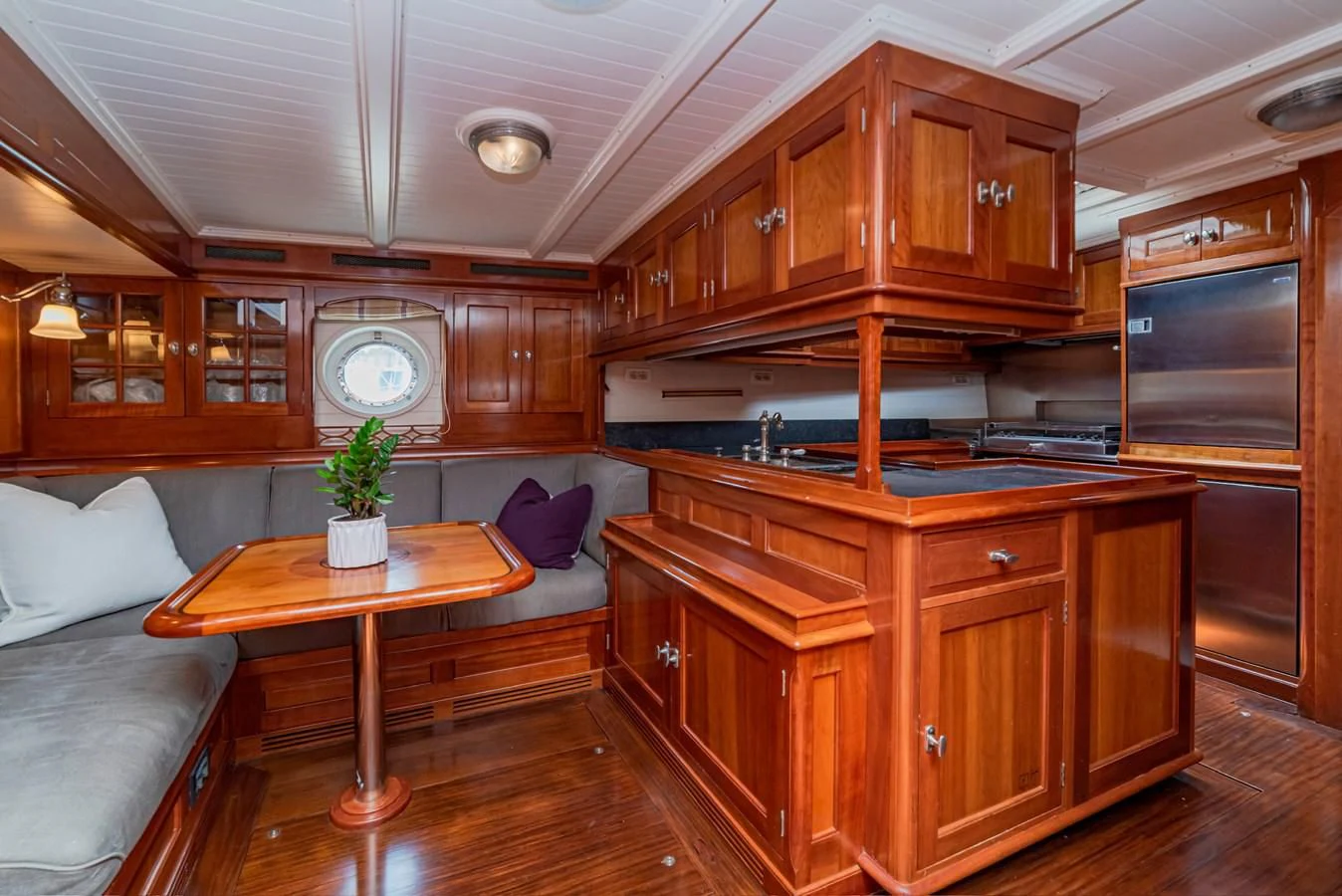 a kitchen with wooden cabinets aboard URIEL Yacht for Sale