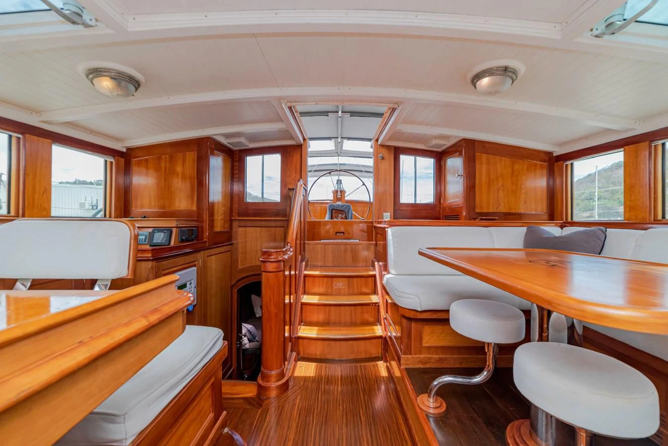 a room with tables and chairs aboard URIEL Yacht for Sale