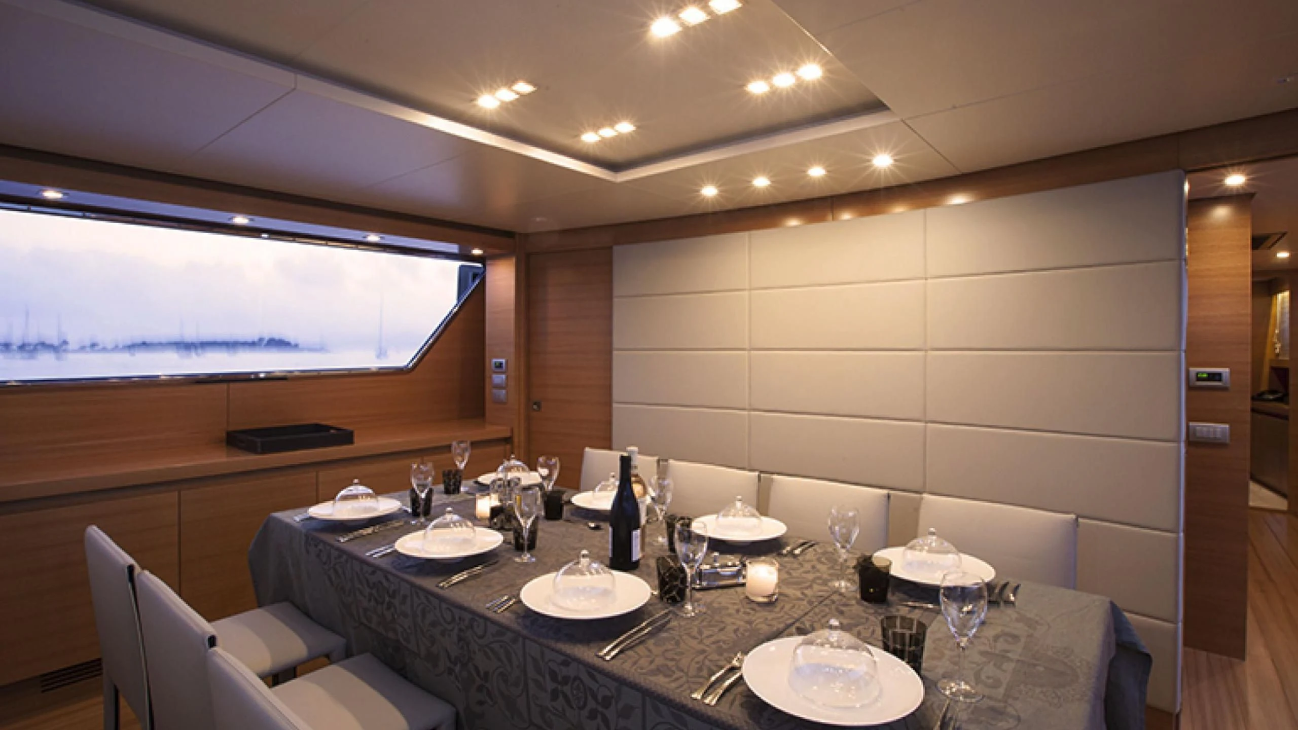 a table with plates and glasses on it aboard PERTULA Yacht for Sale