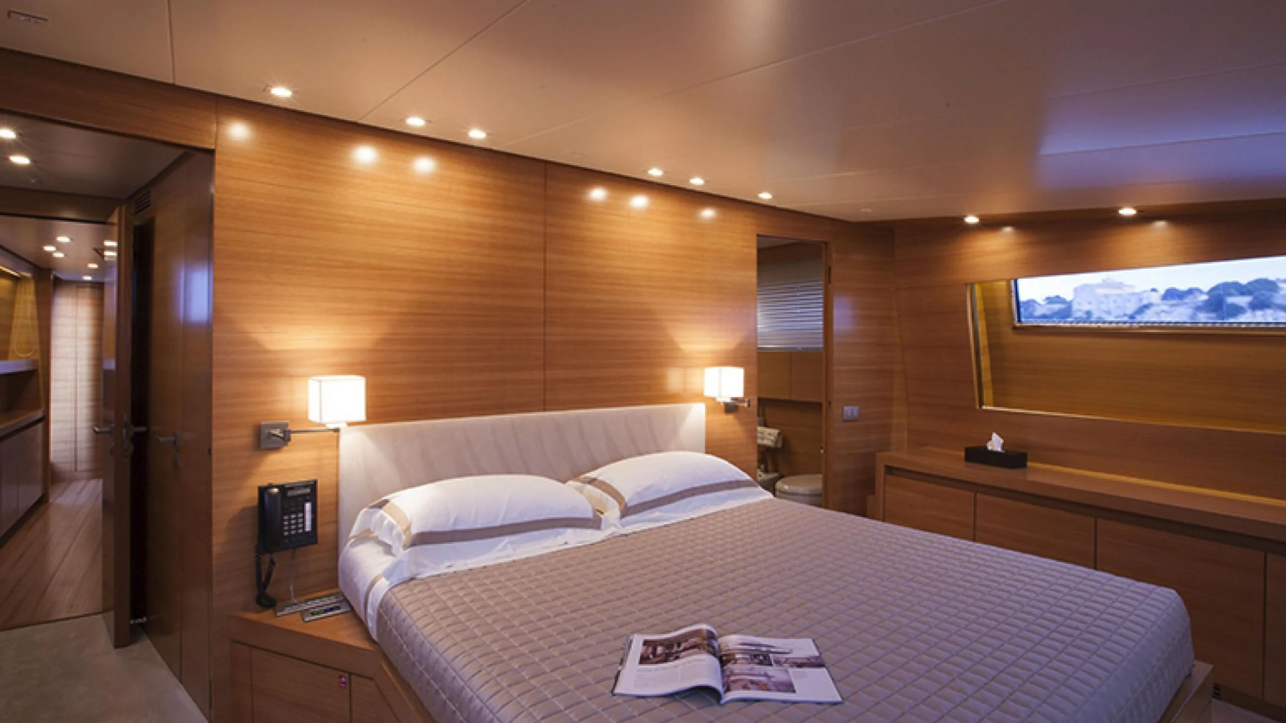 a hotel room with a bed and desk aboard PERTULA Yacht for Sale