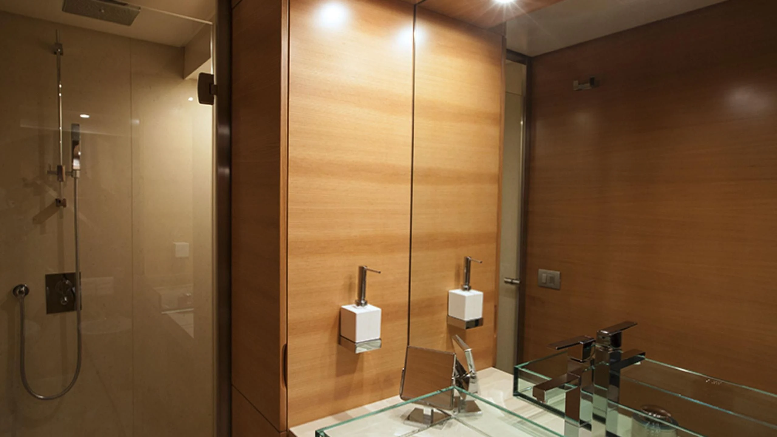 a bathroom with a glass shower aboard PERTULA Yacht for Sale