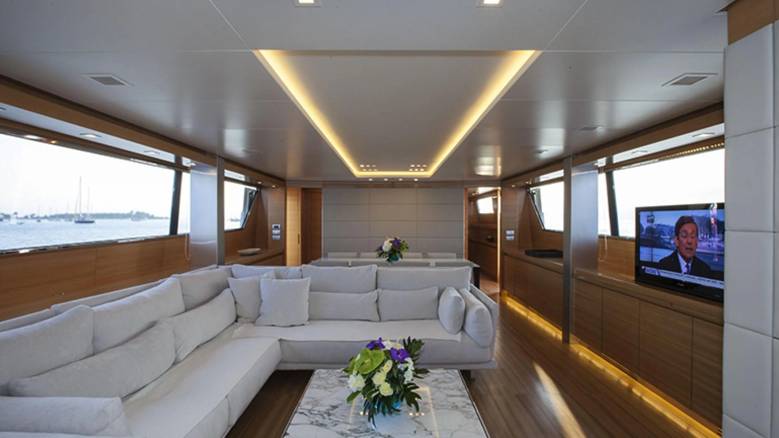 a living room with a large window aboard PERTULA Yacht for Sale