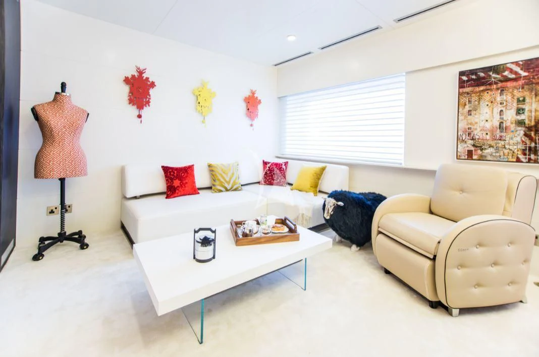 a living room with a white couch and a lamp aboard SALUZI Yacht for Charter