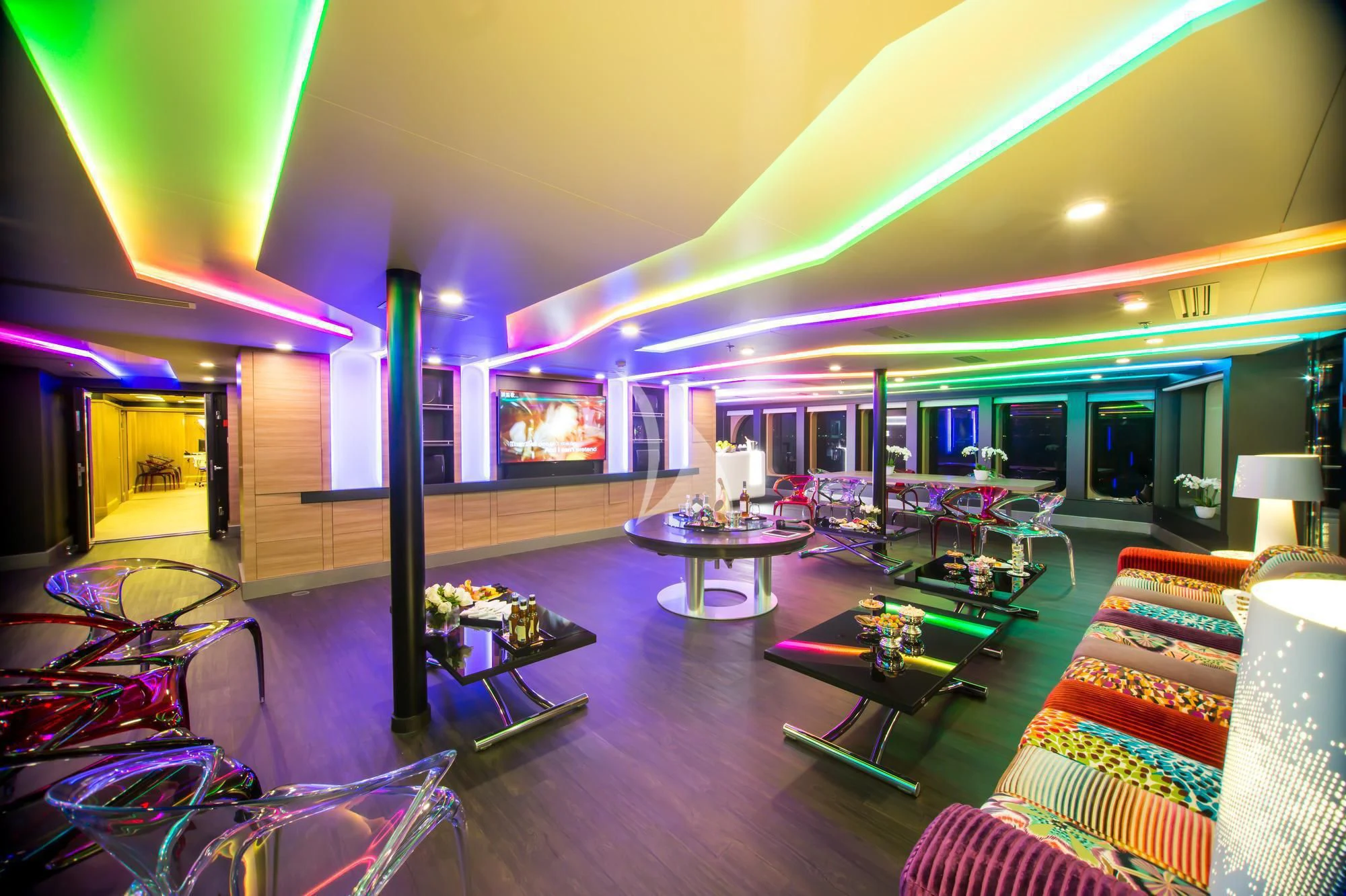 a living room with a large screen aboard SALUZI Yacht for Charter