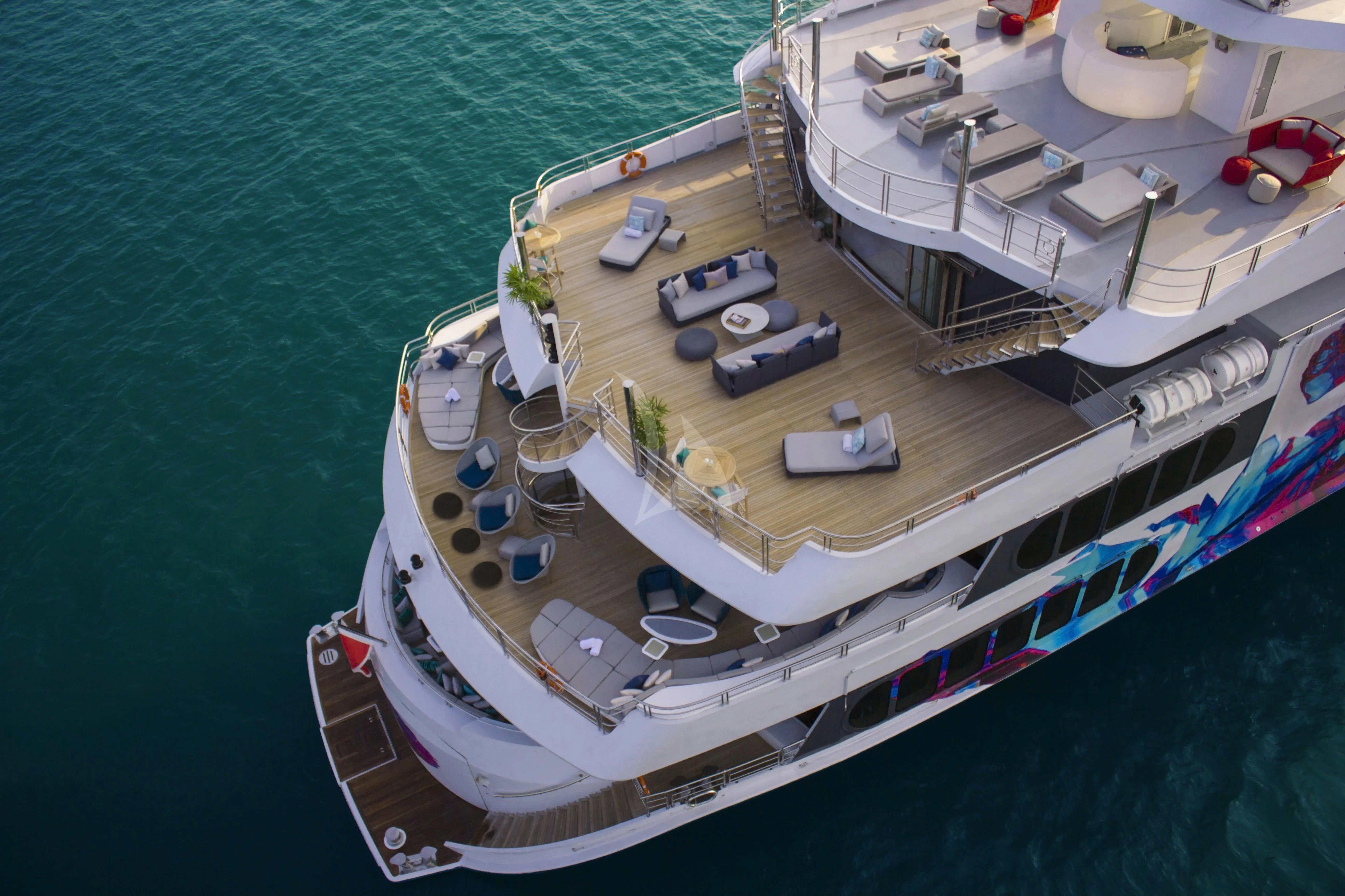 a large ship with a deck and a dock aboard SALUZI Yacht for Charter