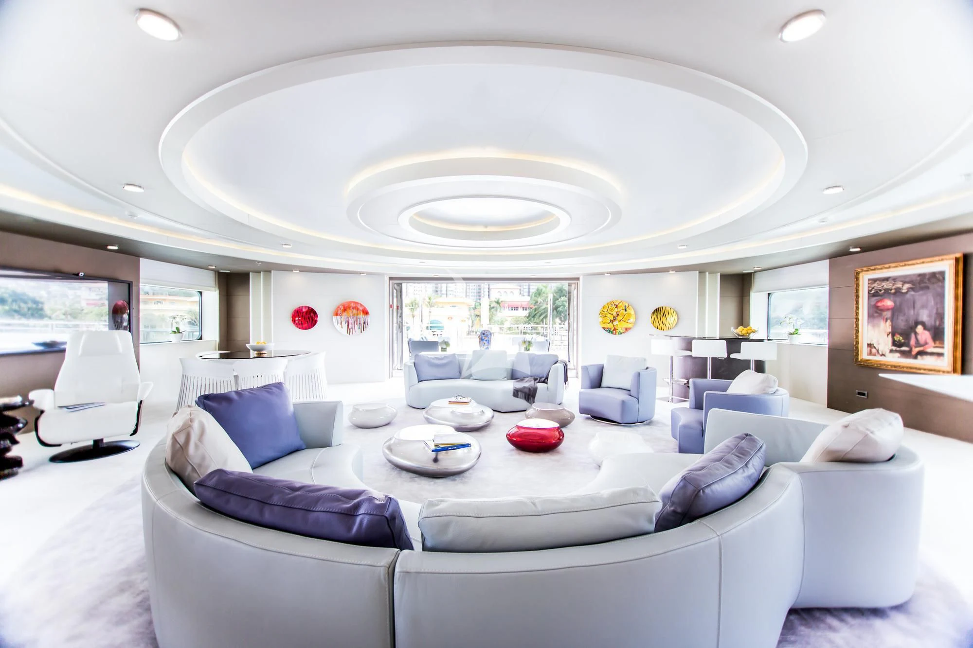 a large white room with a large white bed and a large white couch aboard SALUZI Yacht for Charter