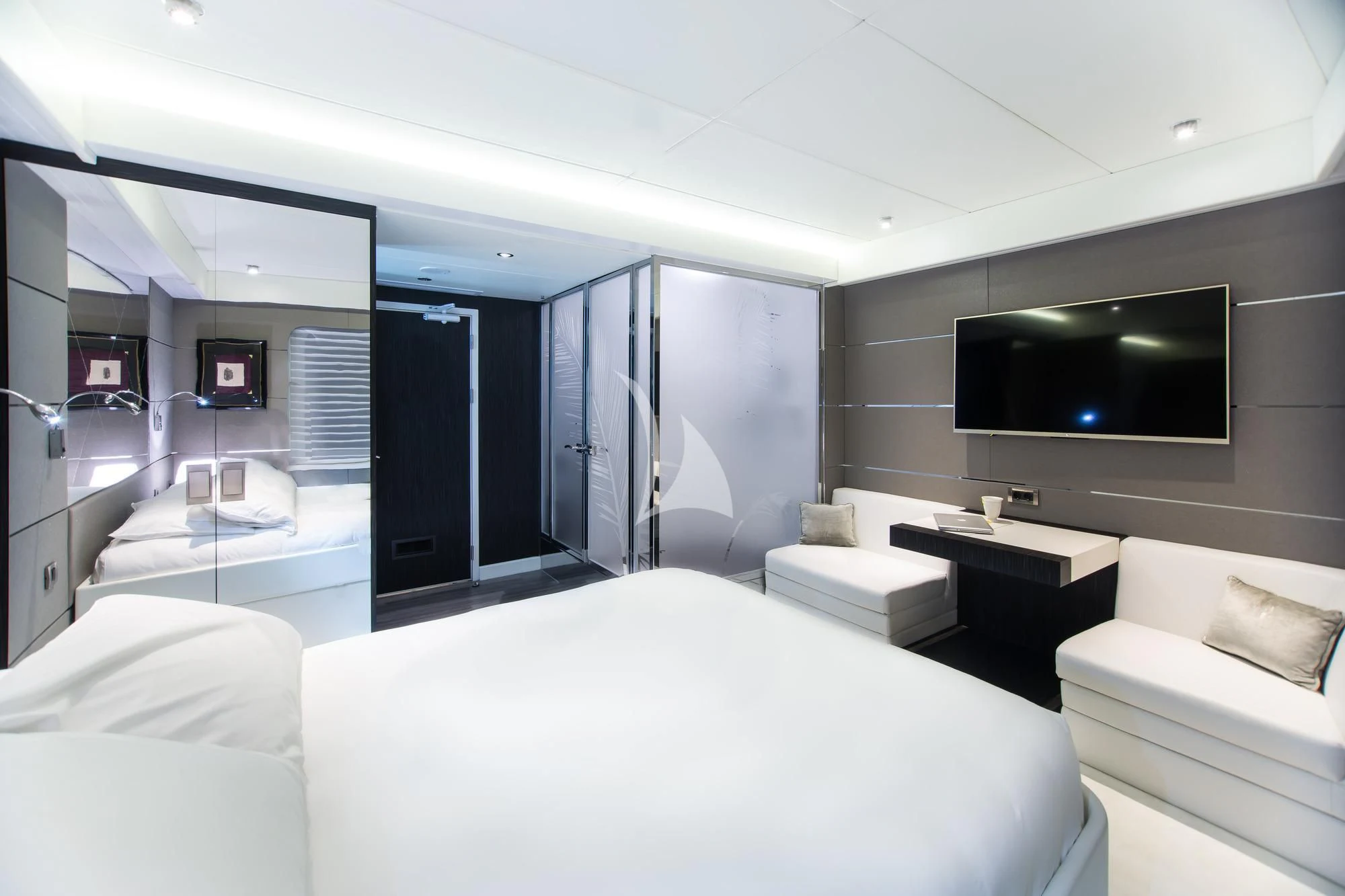 a room with a bed and a tv on the wall aboard SALUZI Yacht for Charter