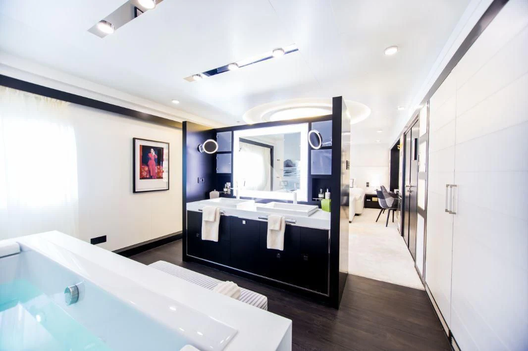 a large bathroom with a large mirror aboard SALUZI Yacht for Charter