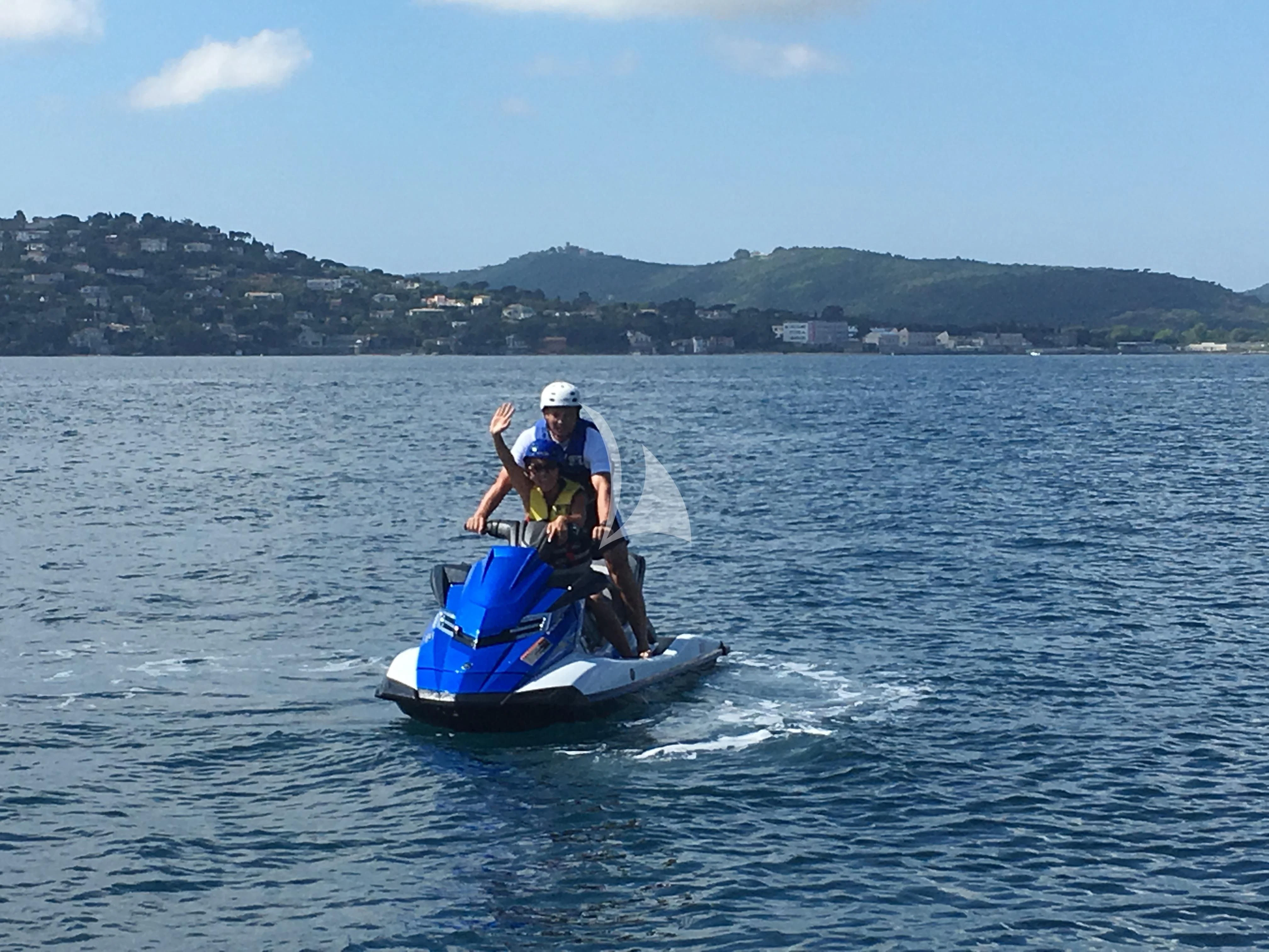 a man and a dog on a small boat in the water aboard SALUZI Yacht for Charter