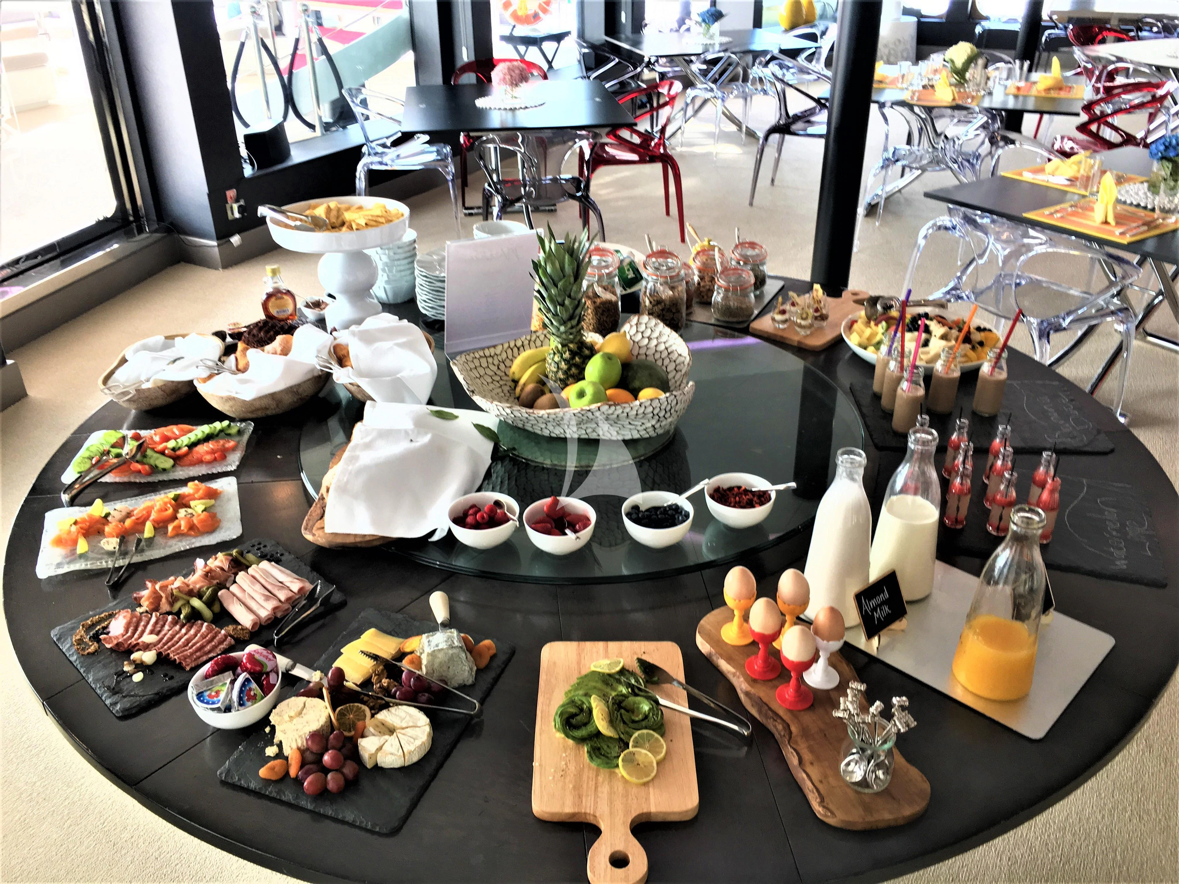 a table with food and drinks aboard SALUZI Yacht for Charter