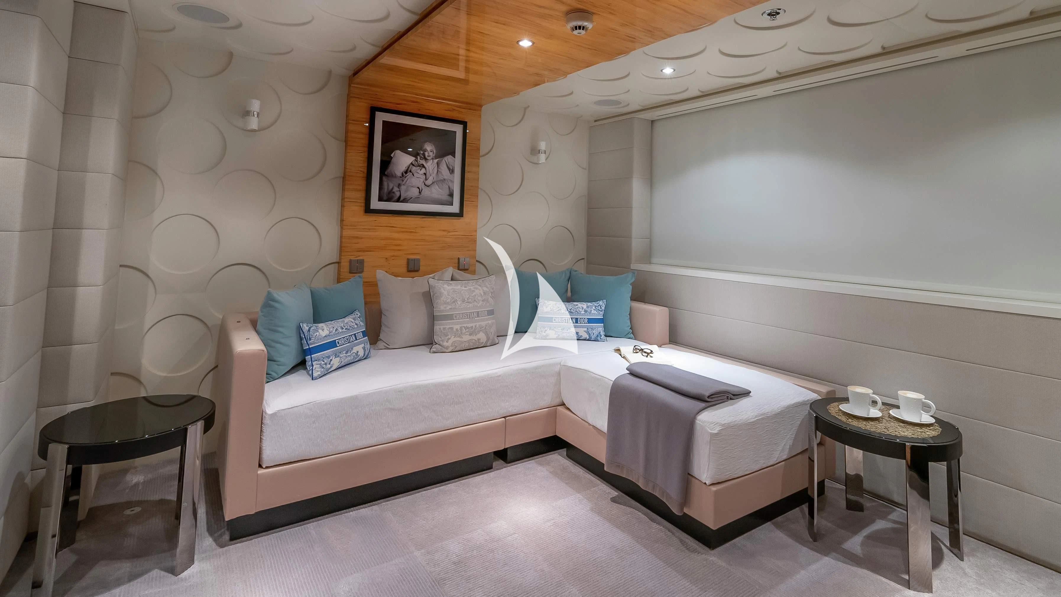 a bed with a white bed and a table with a chair aboard SCOTT FREE Yacht for Charter
