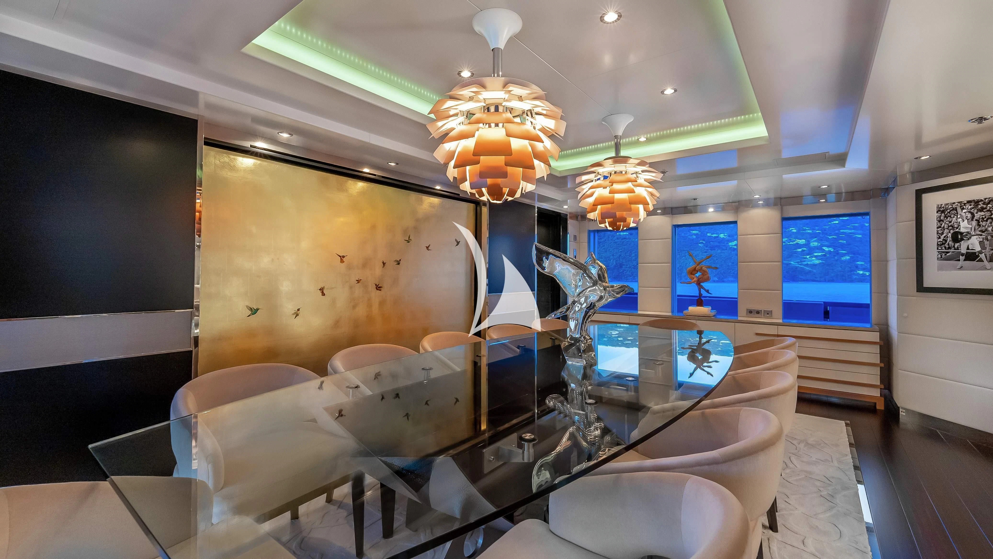 a room with a large chandelier and a large mirror aboard SCOTT FREE Yacht for Charter