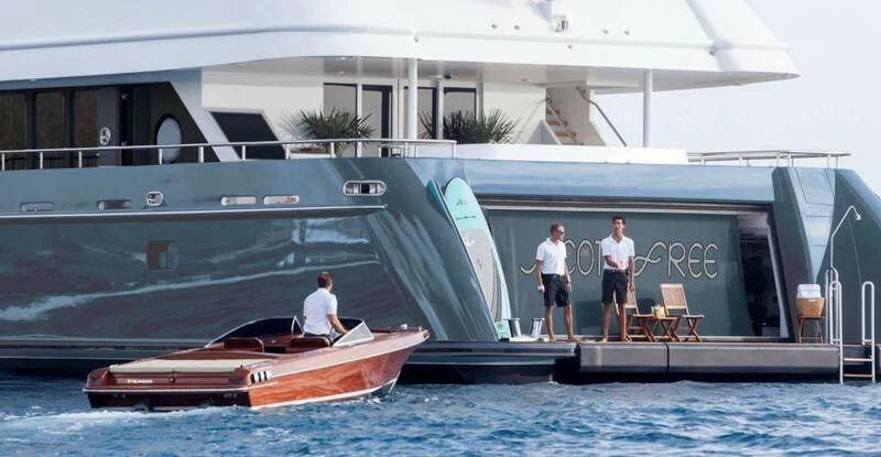a couple of men standing on a boat in the water aboard SCOTT FREE Yacht for Charter