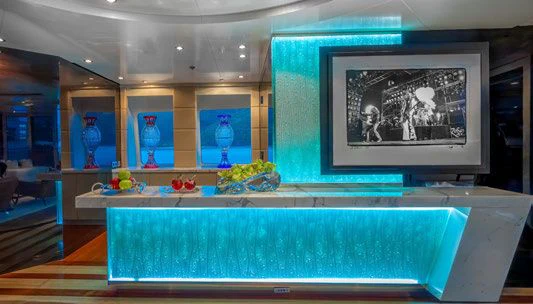 a room with a table and a painting on the wall aboard SCOTT FREE Yacht for Charter