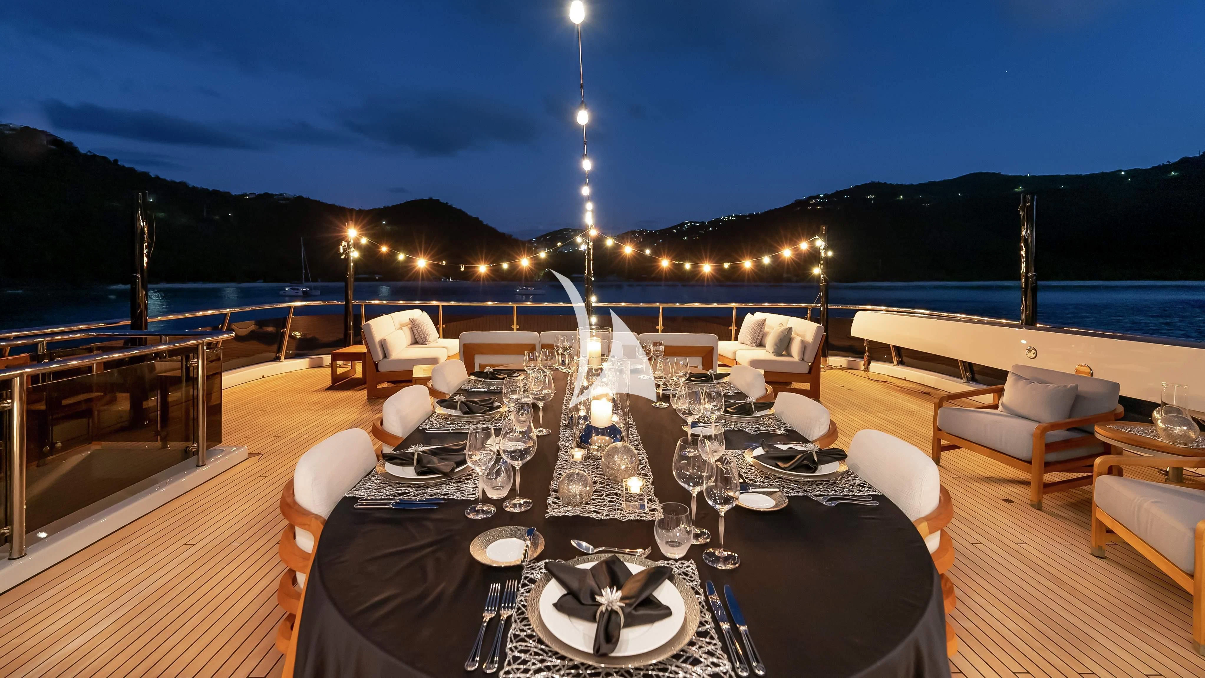 a table with chairs and a view of the ocean aboard SCOTT FREE Yacht for Charter