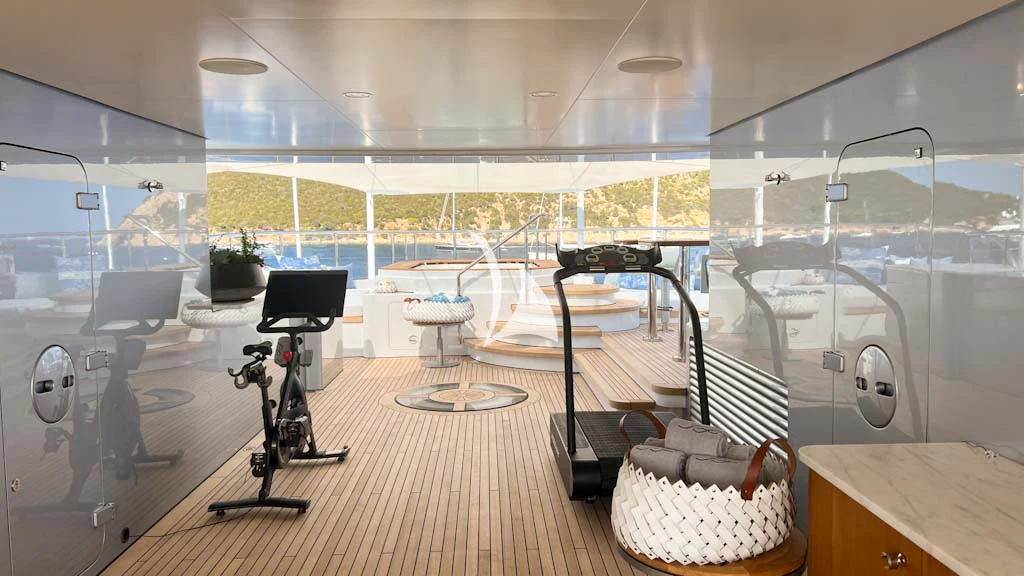 a room with a large window and a table with chairs aboard SCOTT FREE Yacht for Charter