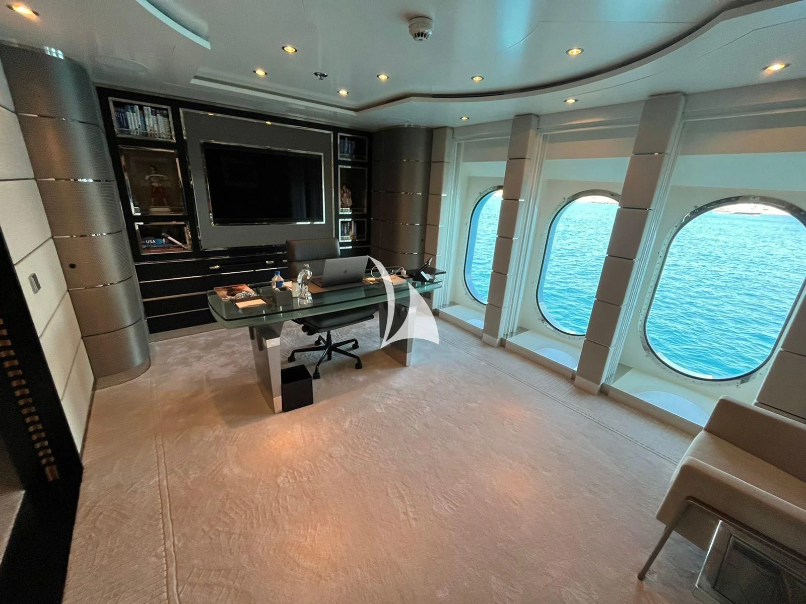 a living room with a tv and a table aboard SCOTT FREE Yacht for Charter