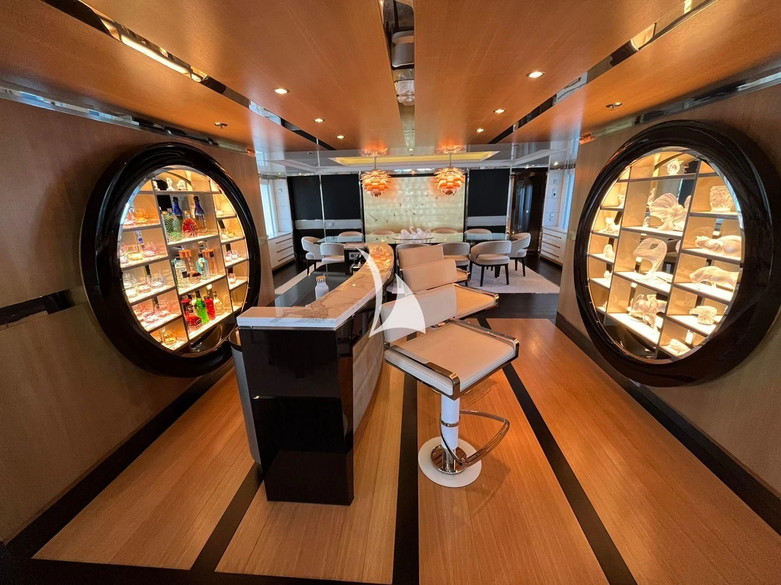 a room with a large mirror and a table with chairs aboard SCOTT FREE Yacht for Charter