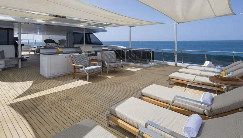 a large lounge area with a large deck and a large pool aboard SCOTT FREE Yacht for Charter