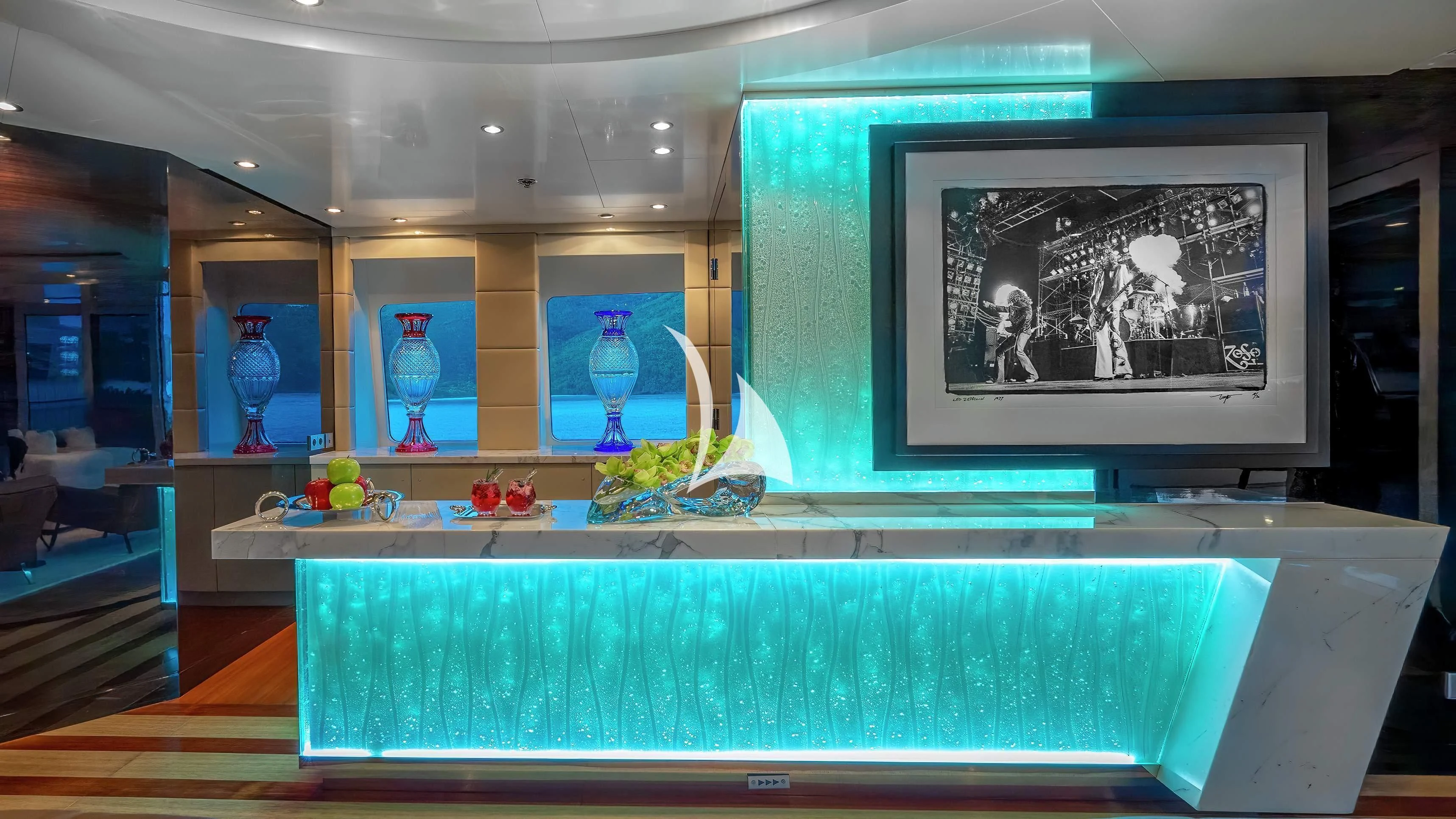 a room with a table and a painting on the wall aboard SCOTT FREE Yacht for Charter