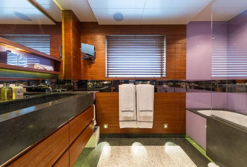 a bathroom with a tub sink and cabinets aboard SCOTT FREE Yacht for Charter
